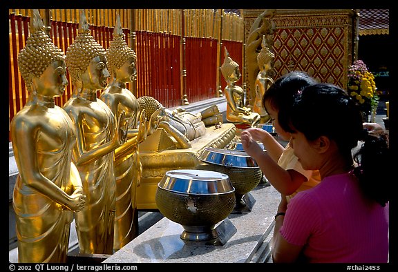 Worshiper makes offering at Wat Phra That Doi Suthep. Chiang Mai, Thailand (color)