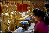 Worshiper makes offering at Wat Phra That Doi Suthep. Chiang Mai, Thailand