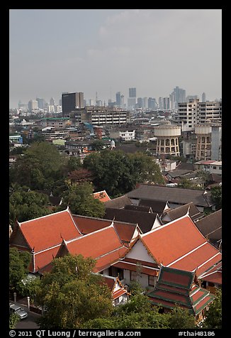 Temple rooftop and modern skyline. Bangkok, Thailand (color)