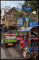 Tuk Tuks and signs. Bangkok, Thailand