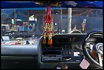 Bus dashboard with religious items. Thailand