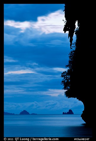 Seascape with limestone islets, stalactite, dusk, Andamam Sea. Krabi Province, Thailand