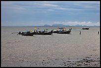 Boats anchored at low tide, storm sky,  Railay East. Krabi Province, Thailand