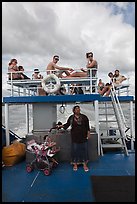 Local woman and tourists on boat, Adaman Sea. Krabi Province, Thailand (color)