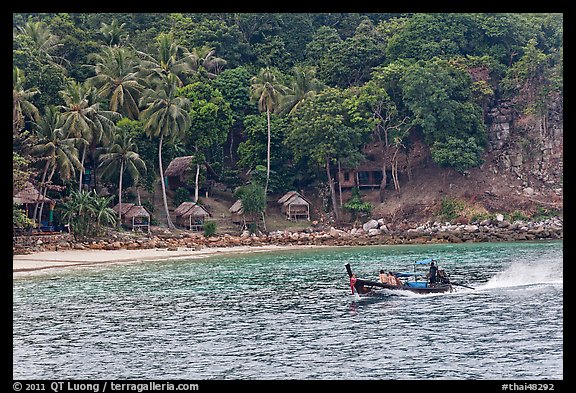 Long tail boat and beach cabins, Ko Phi Phi. Krabi Province, Thailand