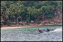 Long tail boat and beach cabins, Ko Phi Phi. Krabi Province, Thailand