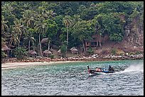 Long tail boat and beach cabins, Ko Phi Phi. Krabi Province, Thailand (color)