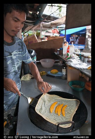 Man preparing thai pancake, Tonsai village, Ko Phi Phi. Krabi Province, Thailand (color)