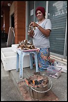 Woman selling grilled seafood, Tonsai village, Ko Phi-Phi island. Krabi Province, Thailand (color)