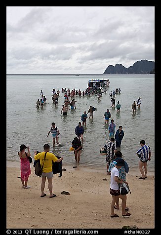 Large group of tourists disembarking from boats, Ko Phi-Phi Don. Krabi Province, Thailand (color)