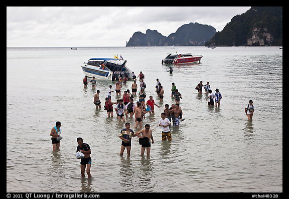 Asian tourists wading in water, Ko Phi Phi. Krabi Province, Thailand (color)