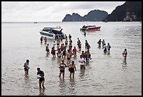 Asian tourists wading in water, Ko Phi Phi. Krabi Province, Thailand