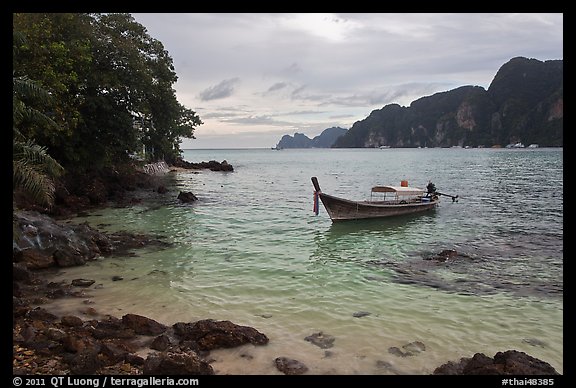 Boat, clear water, stormy skies, Phi-Phi island. Krabi Province, Thailand (color)