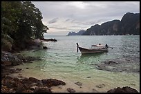 Boat, clear water, stormy skies, Phi-Phi island. Krabi Province, Thailand (color)