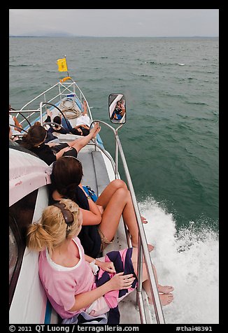 Women sitting on front of boat. Krabi Province, Thailand