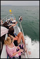 Women sitting on front of boat. Krabi Province, Thailand