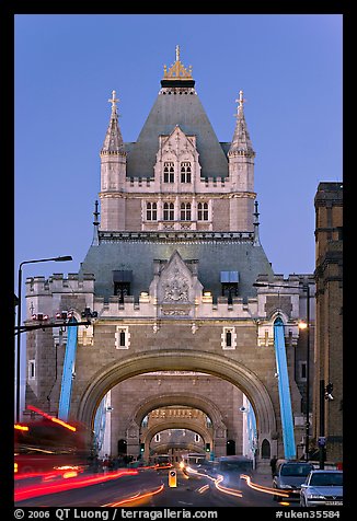 Traffic under arches of the Tower Bridge at twilight. London, England, United Kingdom