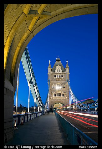 Walkway and road traffic on the Tower Bridge at night. London, England, United Kingdom