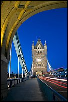 Walkway and road traffic on the Tower Bridge at night. London, England, United Kingdom (color)