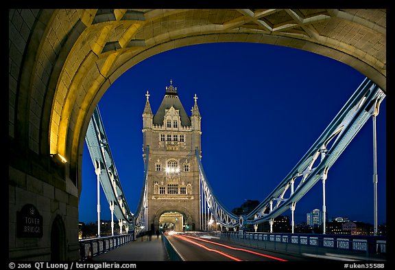 Arch and car traffic on the Tower Bridge at night. London, England, United Kingdom (color)