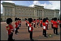 Rows of guards  wearing bearskin hats and red uniforms. London, England, United Kingdom