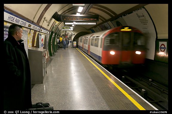 Man waiting for approaching train at Hyde Park subway station. London, England, United Kingdom