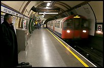 Man waiting for approaching train at Hyde Park subway station. London, England, United Kingdom ( color)