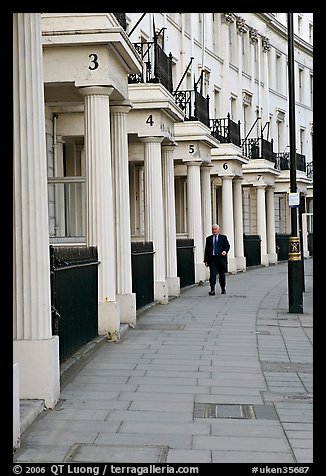 Businessman walking down near townhouses crescent. London, England, United Kingdom (color)