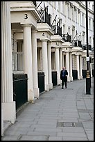 Businessman walking down near townhouses crescent. London, England, United Kingdom (color)
