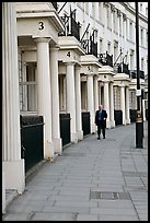 Businessman walking down near townhouses crescent. London, England, United Kingdom