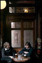 Young men, beer pints, and etched glass, pub Princess Louise. London, England, United Kingdom