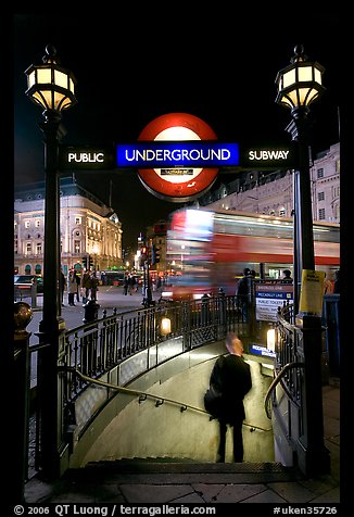 Man entering underground, and motion-blurred double decker bus,  Piccadilly Circus. London, England, United Kingdom