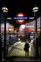 Man entering underground, and motion-blurred double decker bus,  Piccadilly Circus. London, England, United Kingdom (color)