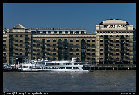 Butler Wharf and tour boat on the Thames. London, England, United Kingdom