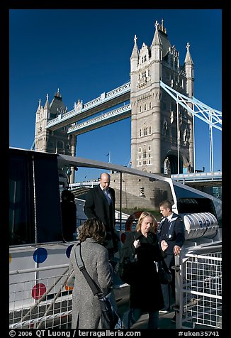 Passengers disembarking a boat in their morning commute, Tower Bridge in the background. London, England, United Kingdom (color)