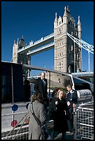 Passengers disembarking a boat in their morning commute, Tower Bridge in the background. London, England, United Kingdom