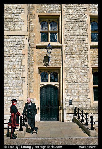 Yeoman Warder talking with man in suit in front of the Jewel House, Tower of London. London, England, United Kingdom