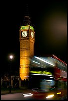 Double-decker bus in motion and Big Ben at night. London, England, United Kingdom (color)