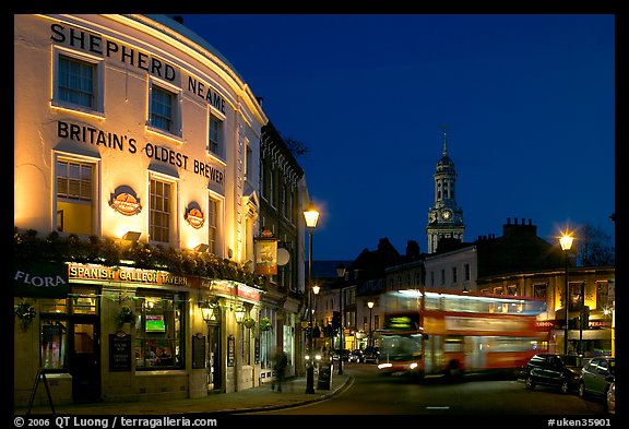 Tavern, moving double decker bus, and church at night. Greenwich, London, England, United Kingdom (color)