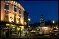 Tavern, moving double decker bus, and church at night. Greenwich, London, England, United Kingdom (color)