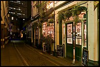 Saloon bar and cobblestone alley at night. London, England, United Kingdom (color)