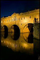 Man looking at the Pulteney Bridge  at night. Bath, Somerset, England, United Kingdom (color)