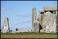 Couple looking at the standing stones, Stonehenge, Salisbury. England, United Kingdom