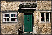 Windows and doorway entrance of stone house, Lacock. Wiltshire, England, United Kingdom