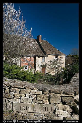 Stone wall with engraved street name, yard and house, Lacock. Wiltshire, England, United Kingdom (color)
