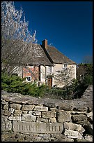 Stone wall with engraved street name, yard and house, Lacock. Wiltshire, England, United Kingdom (color)