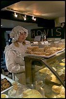 Woman wearing old-fashioned attire in a bakery, Lacock. Wiltshire, England, United Kingdom