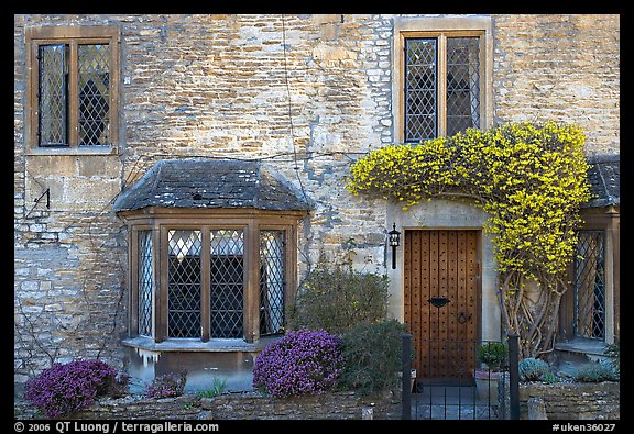 Stone house facade with flowers, Castle Combe. Wiltshire, England, United Kingdom (color)