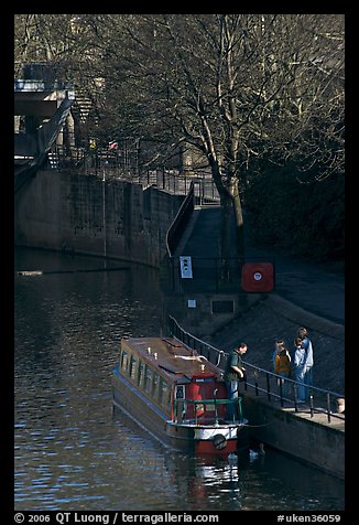 Family stepping out of houseboat onto quay. Bath, Somerset, England, United Kingdom (color)
