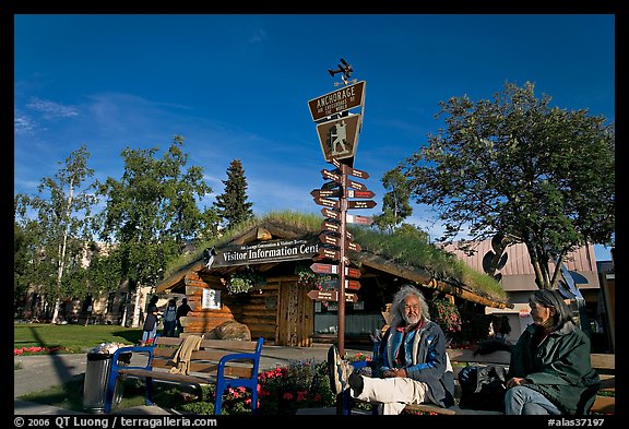 Native people sitting in front of visitor center. Anchorage, Alaska, USA (color)